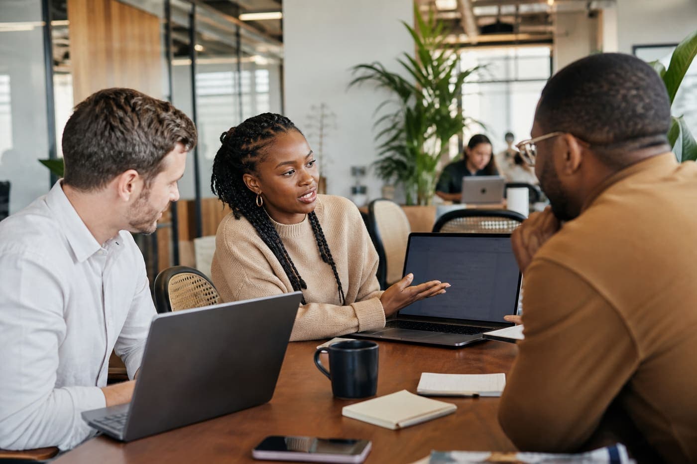 Diverse team collaborating on digital systems in a modern office