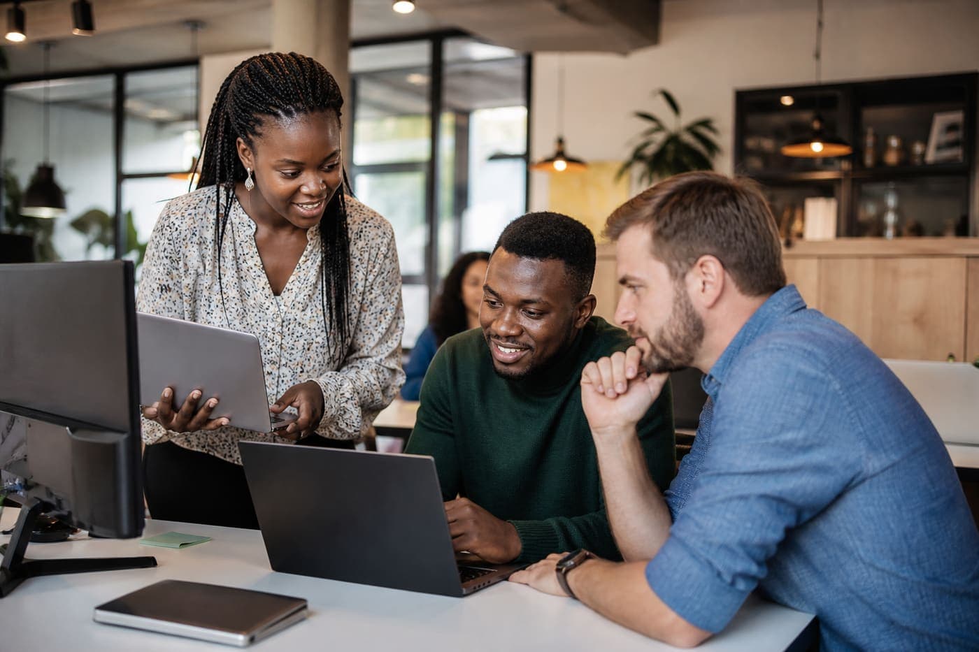 African engineers collaborating over code in a modern workspace
